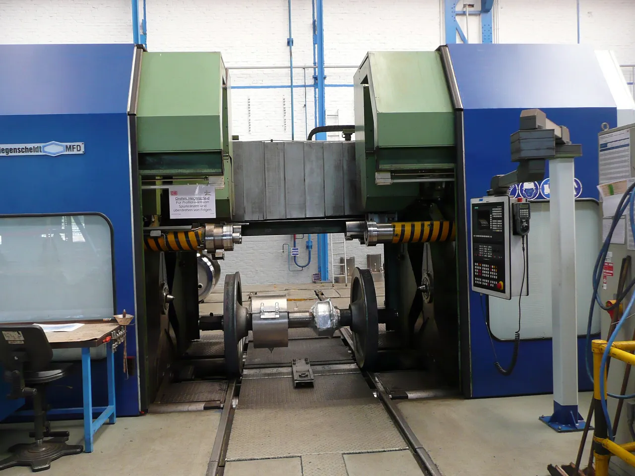 A Hegenscheidt underfloor wheel lathe with a wheelset mounted for re-profiling in a depot workshop