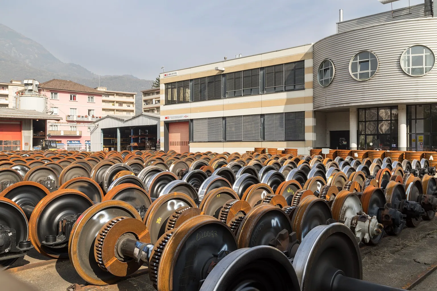 Rows of overhauled railway wheelsets lined up in the SBB maintenance works yard at Bellinzona